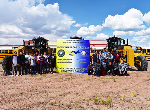 Road crew with Working in Partnership sign