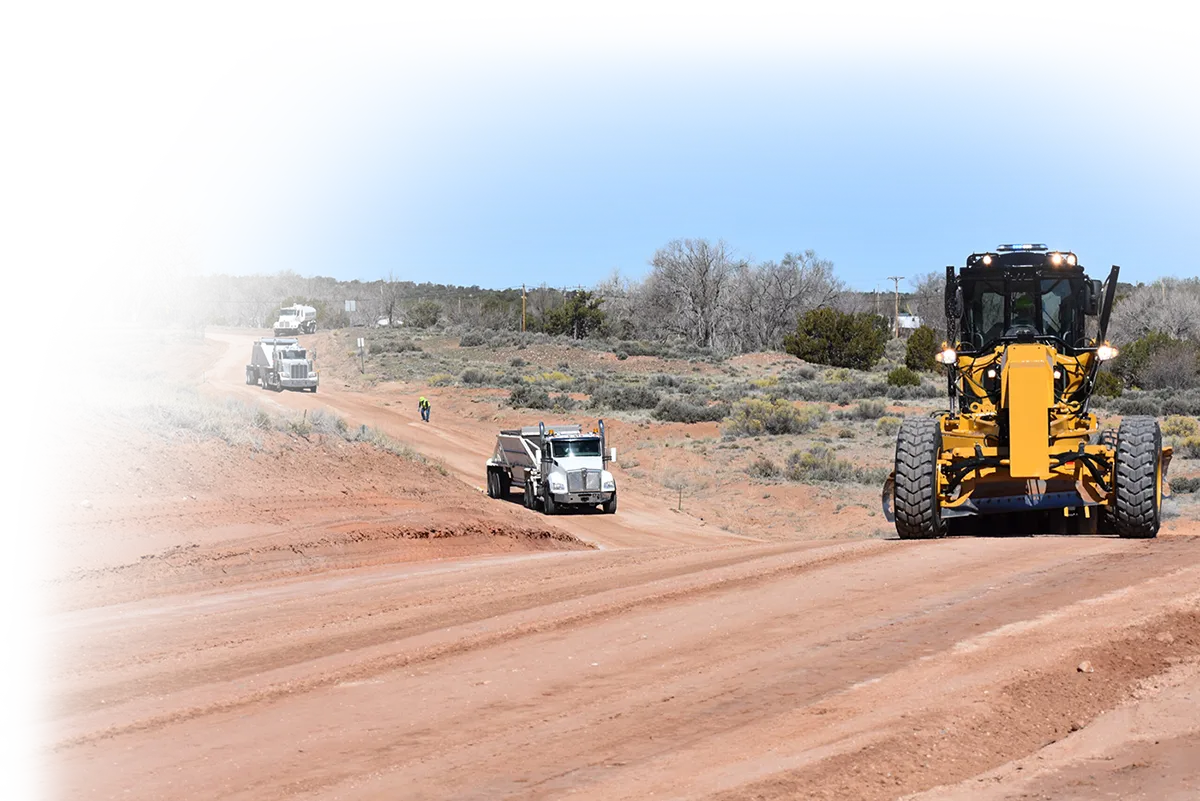 Vehicle grading a curved dirt road